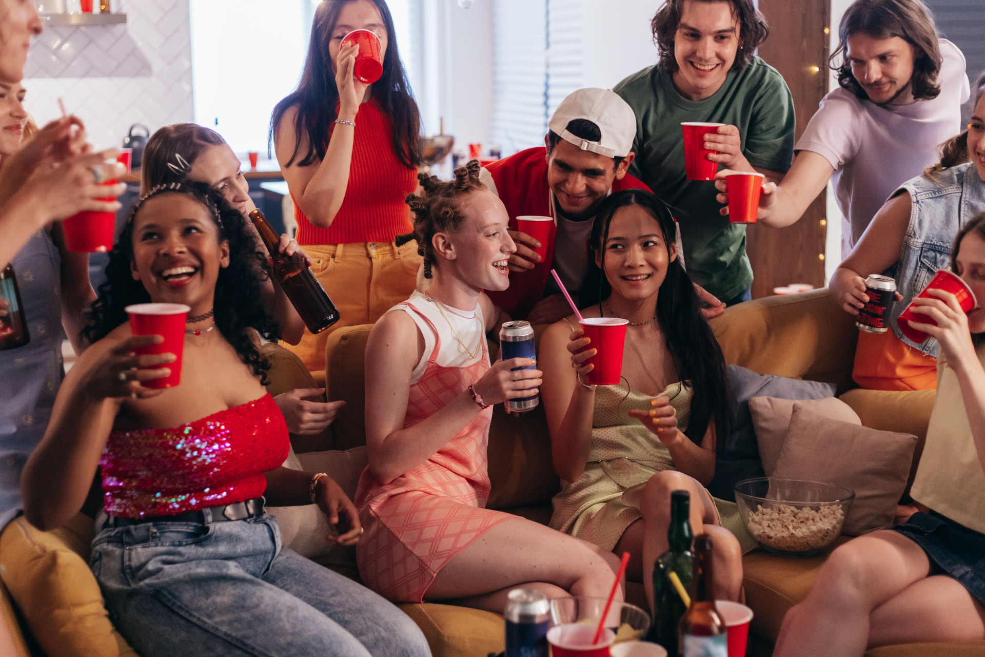 Friends enjoying a party with drinks and snacks